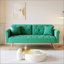 Luxueux canapé-lit en velours vert avec garniture cloutée et coussin décoratif assorti pour un confort élégant