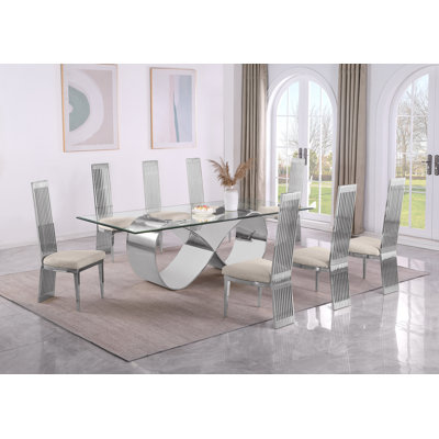 Ensemble repas haut de gamme avec table en verre transparent et structure en acier inoxydable