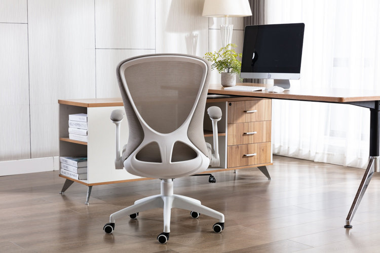 modern home office with white walls, an ergonomic desk chair, and an L-shaped desk