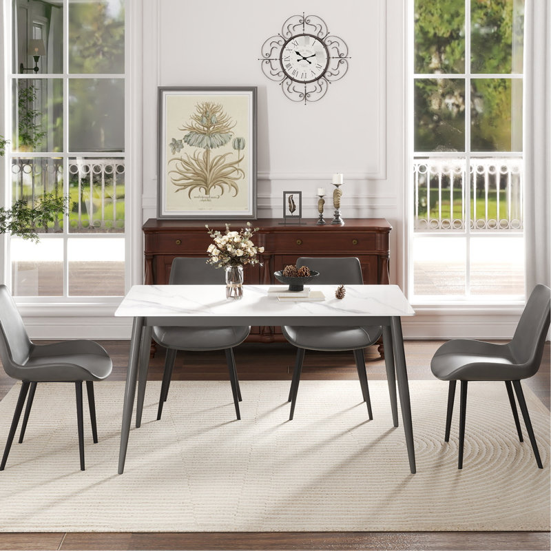 Table de salle à manger rectangulaire en pierre frittée, pieds en métal gris foncé, résistant aux radiations et à la chaleur, facile à nettoyer.