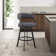 Dehn Modern Swivel Counter or Bar Height Barstool with Open Back and Footrest in Metal and Faux Leather