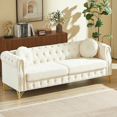 82-Inch Velvet Chesterfield Sofa With Two Round Pillows, Featuring Copper Stud Detailing And Tufted Button Accents, With Metal Legs. Loop Design Allows For Hanging Cartoon Ornaments.