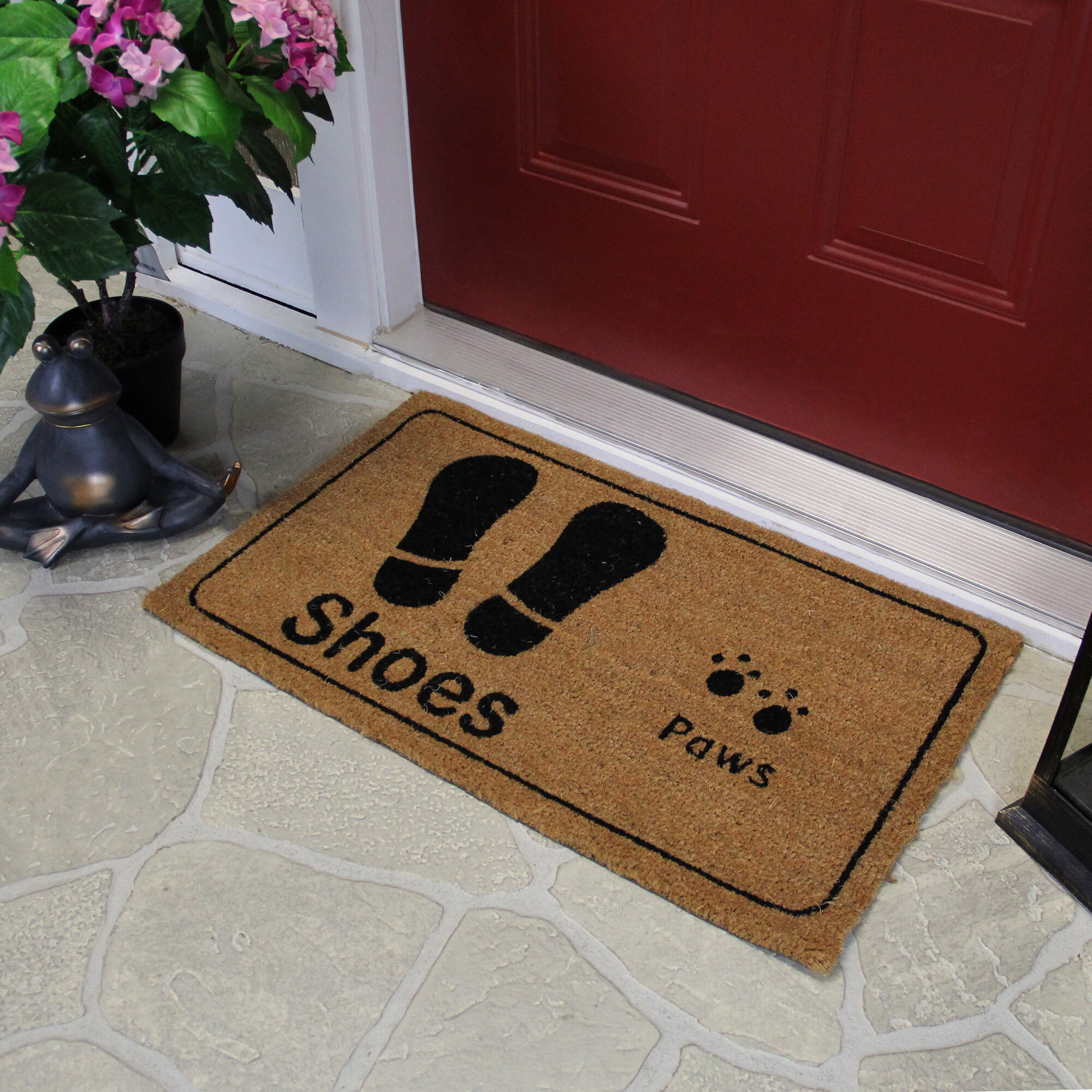 https://assets.wfcdn.com/im/61914375/compr-r85/9734/97346521/beige-and-black-shoe-prints-with-paw-prints-doormat-18-x-30.jpg