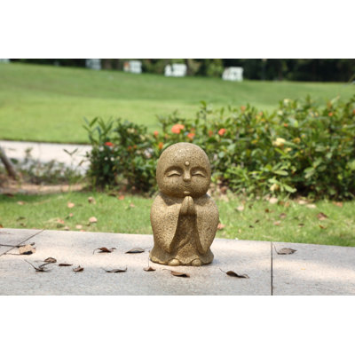 Statue Jizo japonais heureux et priant