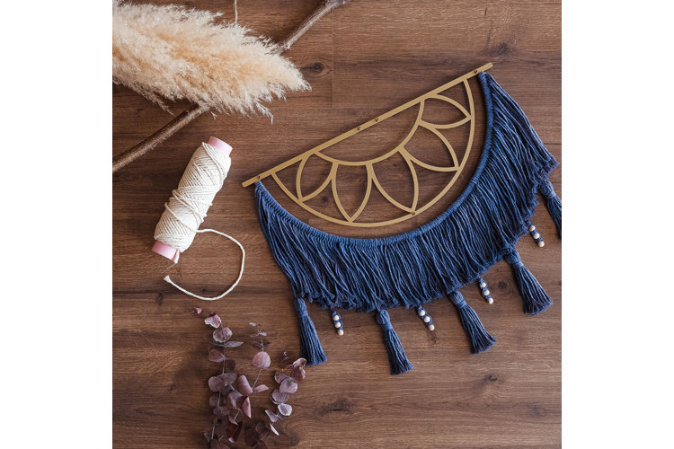 large macramé artwork with crafting products and tools