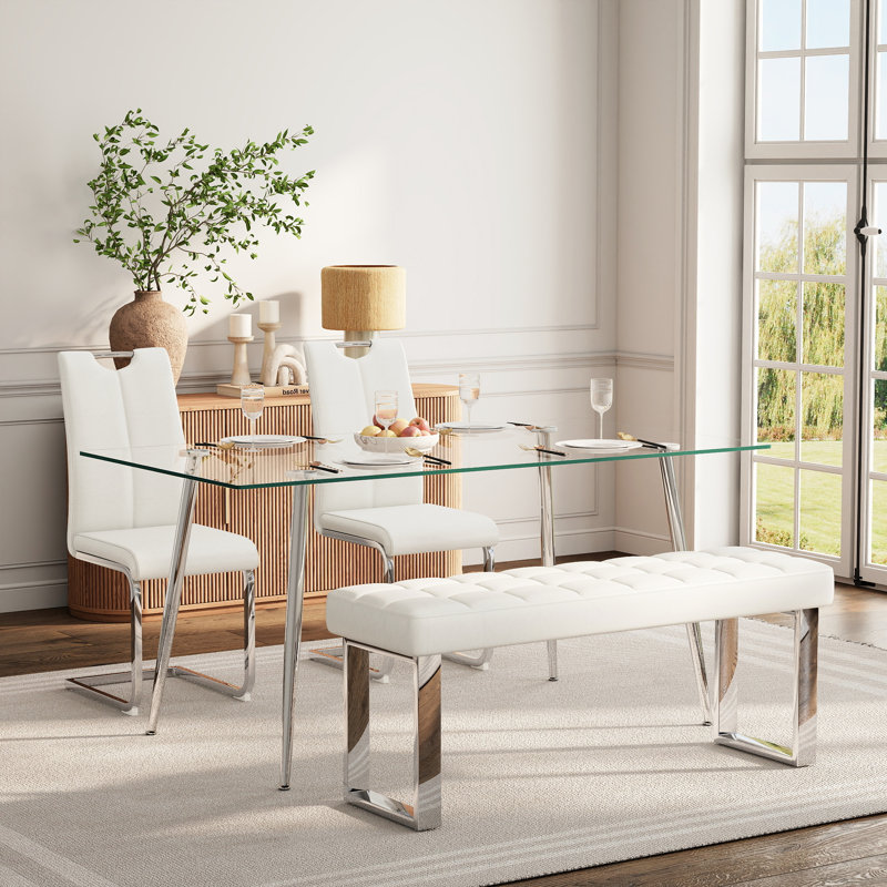 Ensemble de salle à manger en verre pour 4 à 6 personnes, de style moderne, comprenant une table de cuisine rectangulaire en verre, des chaises rembourrées en similicuir et un banc.