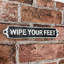 Please Wipe Your Feet Metal Wall Sign | Humorous Decorative Hand Finished Plaque for Entryway, Hallway, Home, or Office