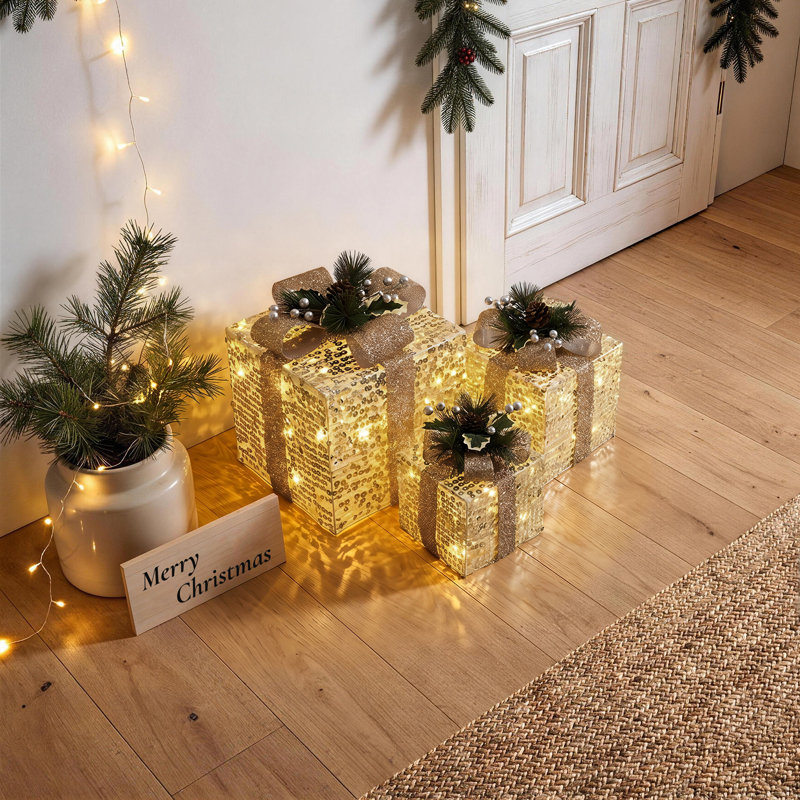 Coffret-cadeau de 3 pièces à paillettes dorées avec décorations de pommes de pin et de baies, illuminé pour les fêtes de fin d'année.