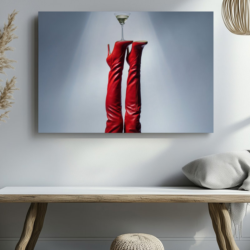 Toile d'une composition saisissante avec une paire de cuissardes rouges lustrées, des bottes à talon aiguille élégamment positionnées vers le haut contre une toile murale