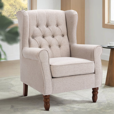 Petit fauteuil d'appoint à oreilles capitonné avec accoudoirs roulés et coussin rembourré épais