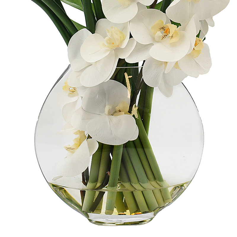 Orchids, Calla Lily And Philodendron Leaves Arranged In A Clear Circular Glass Vase