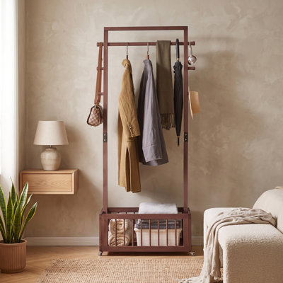 Freestanding Solid Pine Wood Garment Rack with Rolling Wheels, Storage Basket, and Side Hooks in Walnut Finish