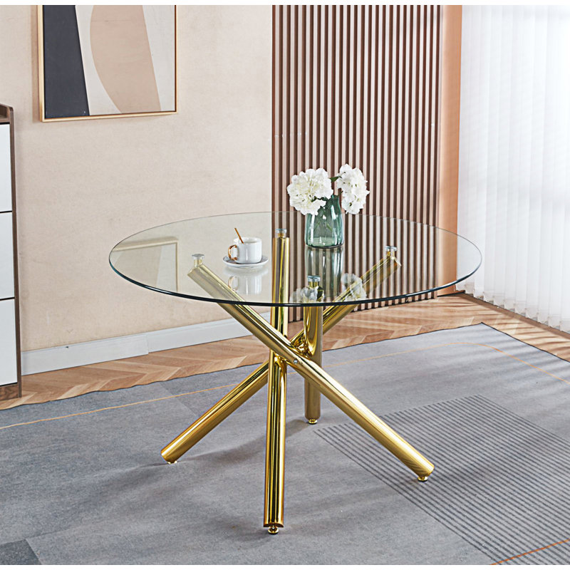 Table de salle à manger en verre avec pieds en métal