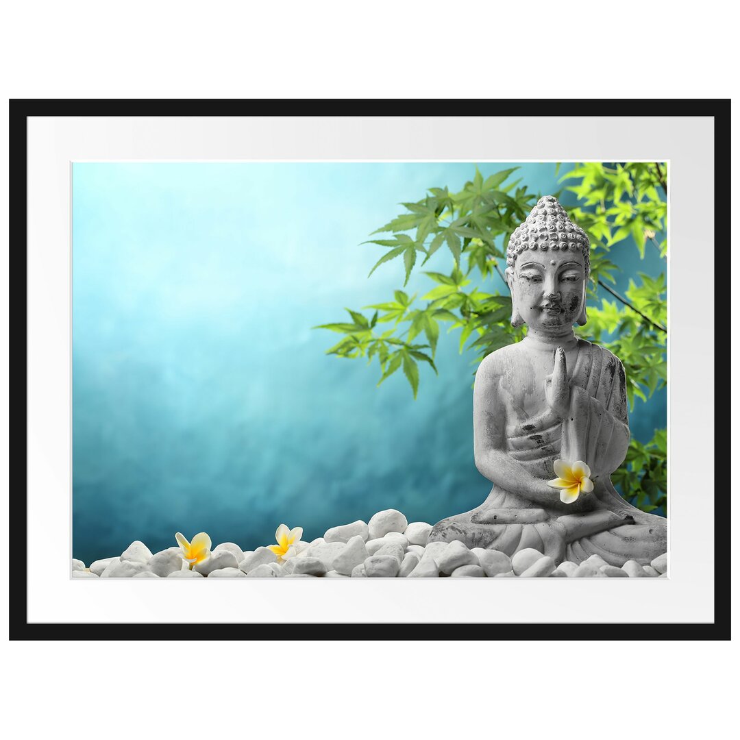 Gerahmtes Poster Buddha auf Steinen mit Monoi Blüte