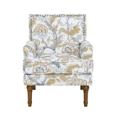 Fauteuil à imprimé botanique avec garniture cloutée et pieds en bois massif