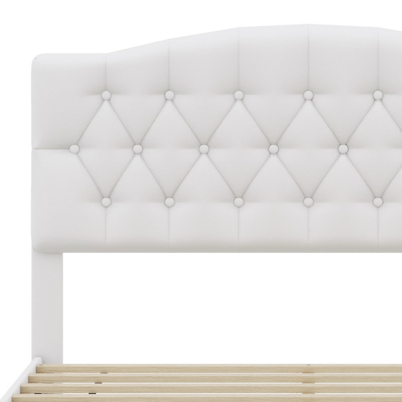 Lit plateforme tapissier avec tête de lit courbée et détails capitonnés