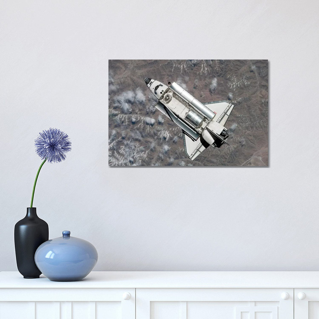 Aerial View Of Space Shuttle Discovery Over Earth As It Approaches The International Space Station by Stocktrek Images - Wrapped Canvas Print
