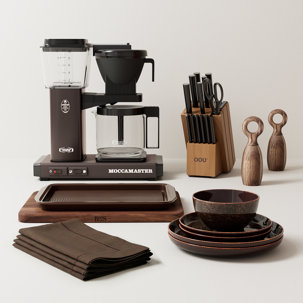 Moccamaster coffee maker, OOU knives, and table setting.