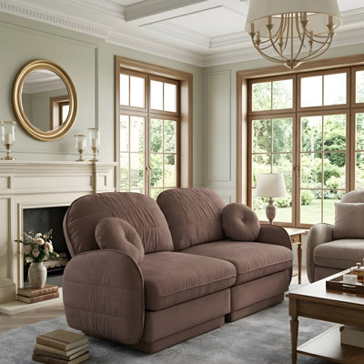 A deep-seated sofa in the living room, complete with round cushions