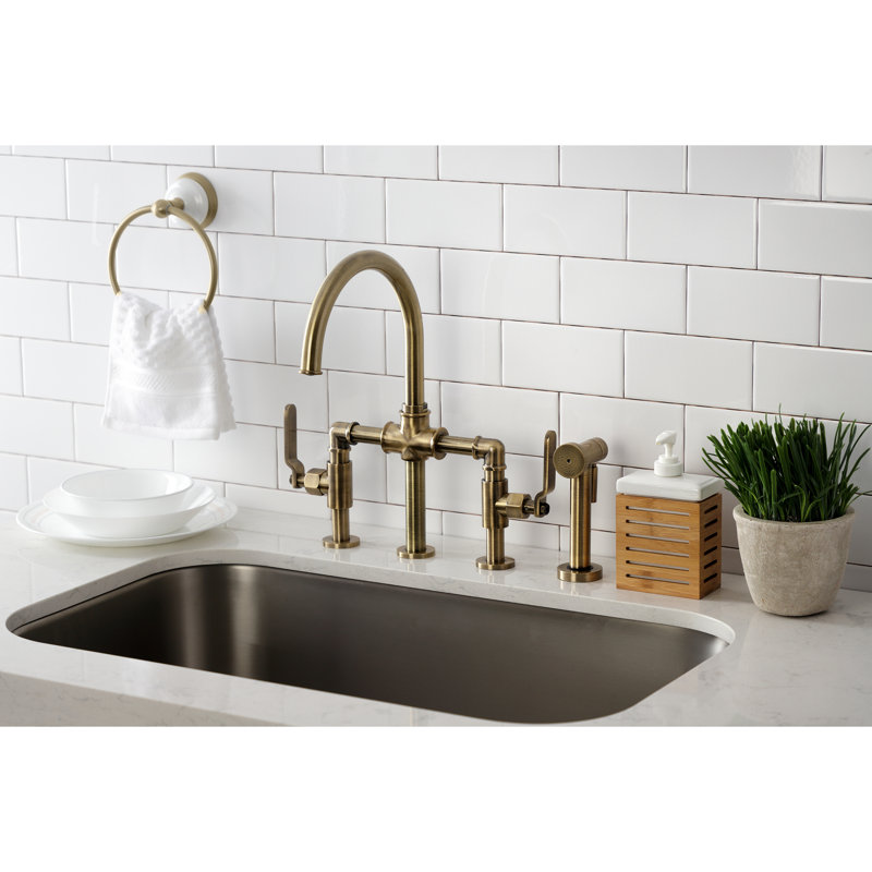 Kingston Brass Two-Handle 4-Hole Deck Mount Industrial Style Bridge Kitchen Faucet with Brass Side Sprayer, Antique Brass