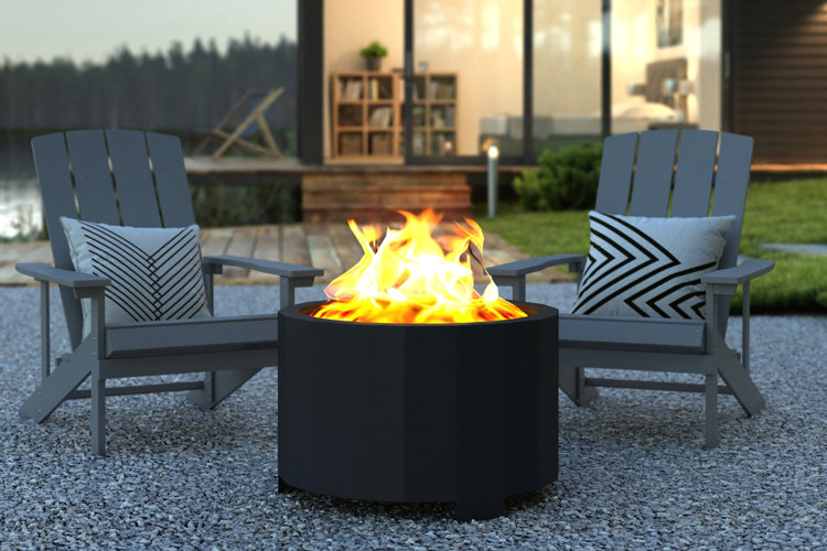 two gray adirondack chairs next to a black smokeless fire pit
