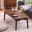 Table basse à quatre pieds en bois massif