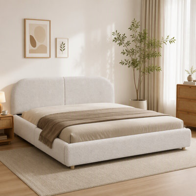 Cadre de lit rembourré avec tête de lit courbée haute, tiroir de rangement à roulettes et pieds robustes.
