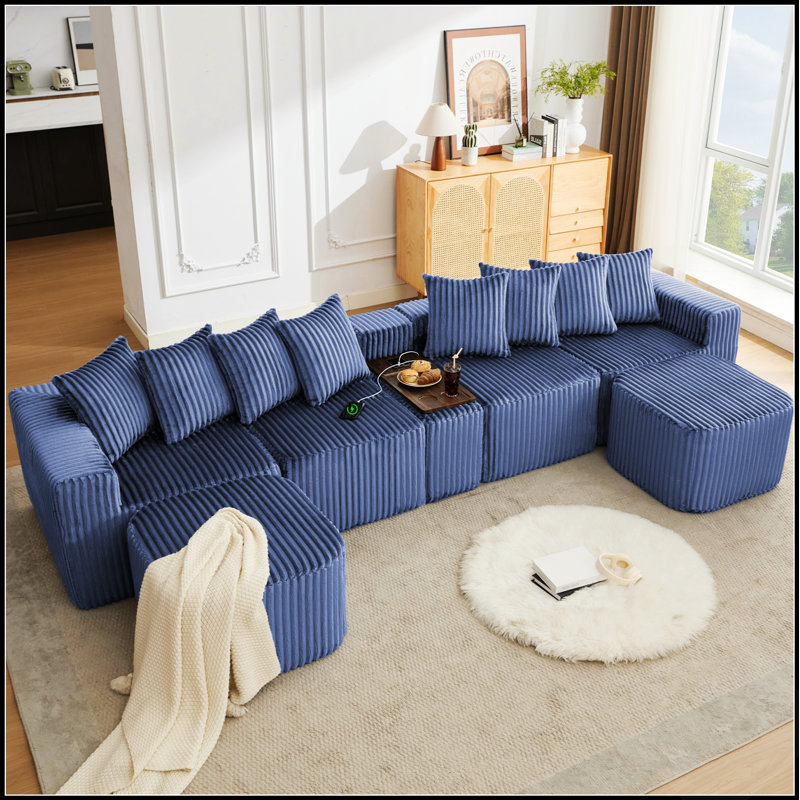 Canapé spacieux en velours côtelé en forme de U avec ports USB et chargeur sans fil, table basse et repose-pieds amovibles pour plus de confort et de commodité.