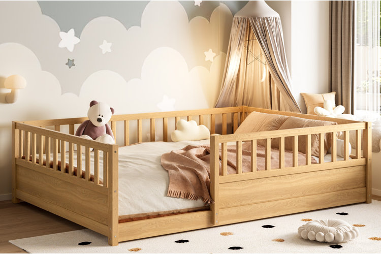 wood montessori floor bed with slatted guardrails in neutral toddler room