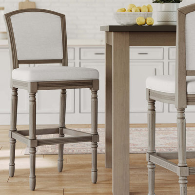 Tabouret de bar gris patiné avec assise et dossier rembourrés gris