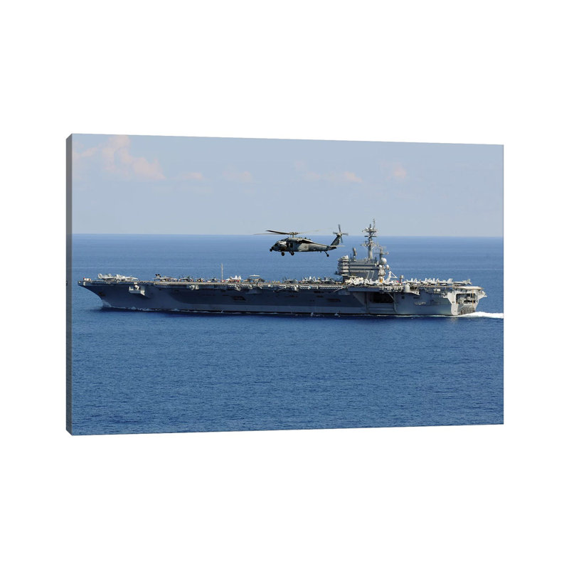 An MH-60S Seahawk Helicopter Flies Over USS George H.W. Bush by Stocktrek Images - Wrapped Canvas Print