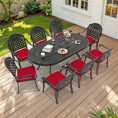 Table de salle à manger d'extérieur ovale en aluminium moulé de 81,89 po L avec trou pour parasol et 8 chaises empilables avec coussins rouges (ensemble de 9 pièces)