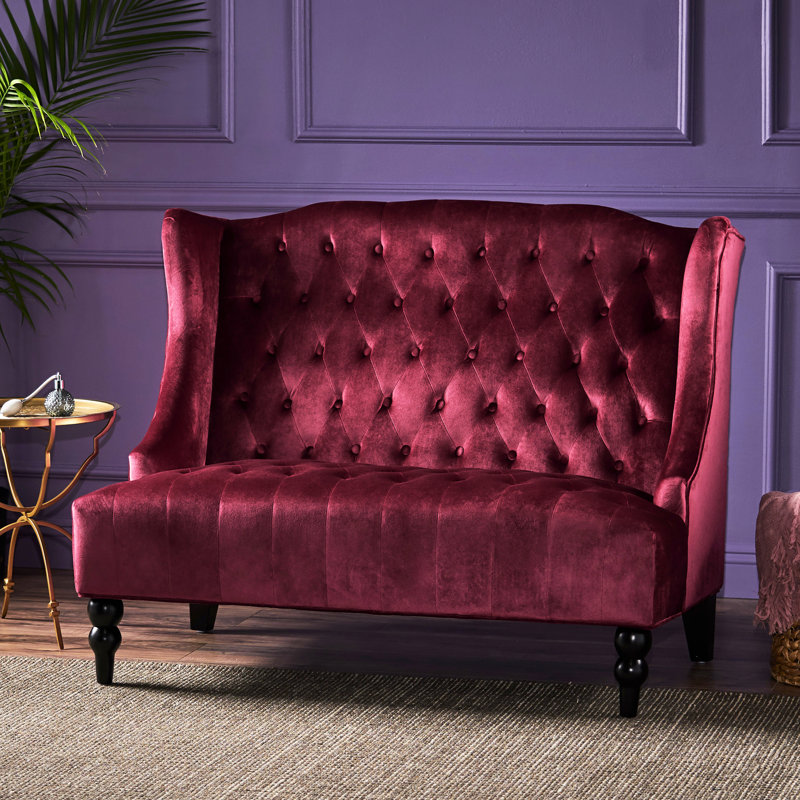 Élégant fauteuil à oreilles en velours avec coussins à boutons - Rouge vineux avec détails touffetés