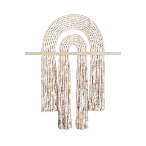 Boho-style wall hanging featuring cream-colored rope arcs and hanging tassels suspended from a light wood horizontal bar.
