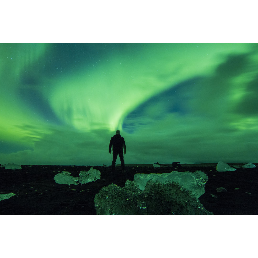 Man Watching Display Of Aurora Borealis by SimonSkafar - Drucken