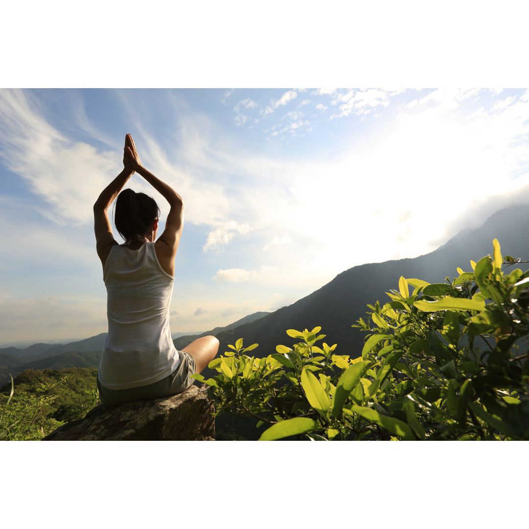 Leinwandbild Young Yoga Woman at Sunrise Mountain Peak