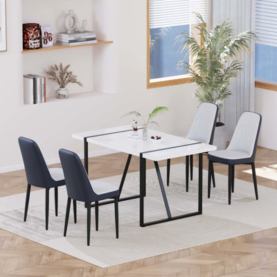 Table de salle à manger de 55 po pour 4 personnes avec plateau de table, pieds en métal noir et chaises en polyuréthane rembourrées et épaisses ergonomiques pour famille
