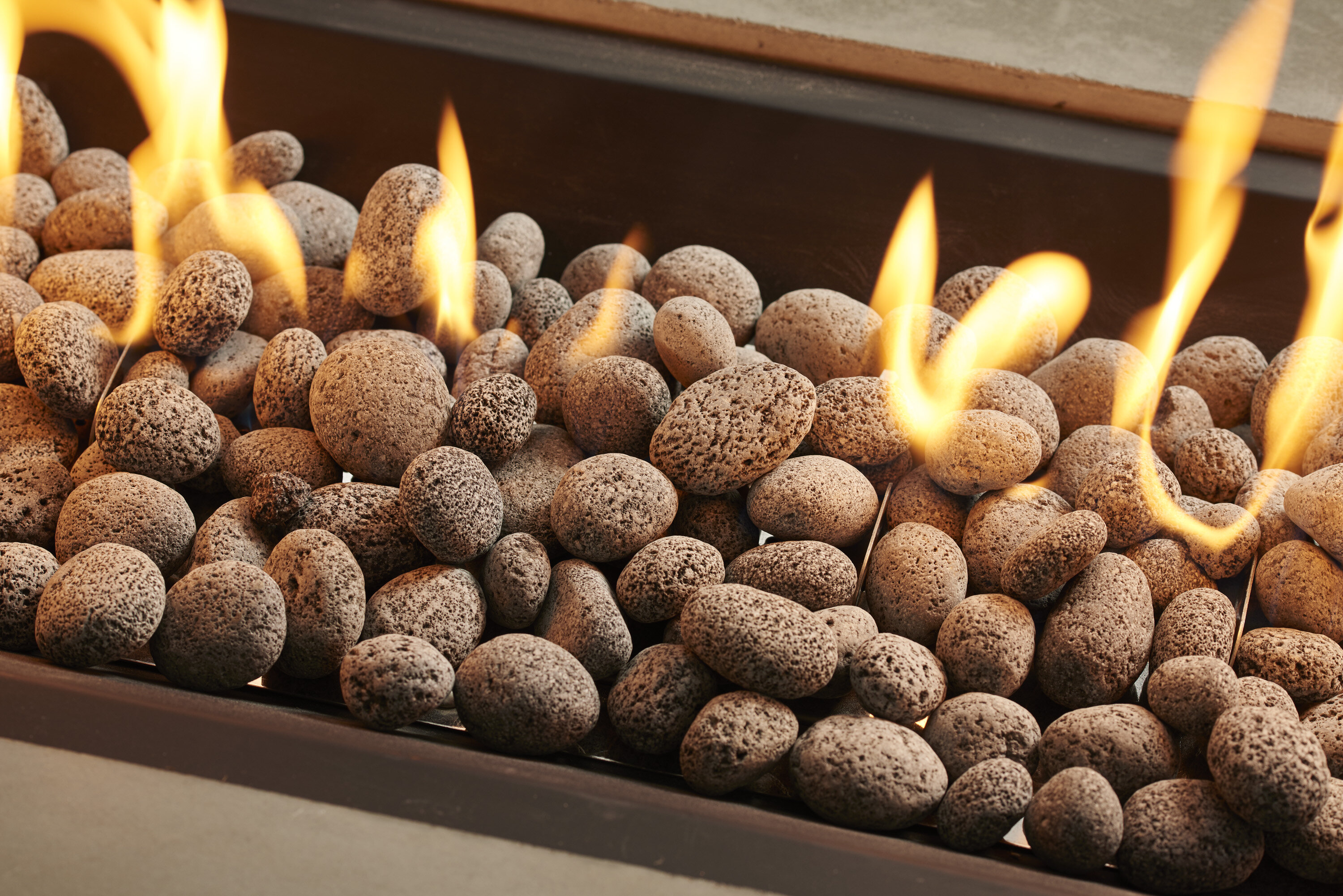 Flames rising from a gas fireplace filled with lava rocks