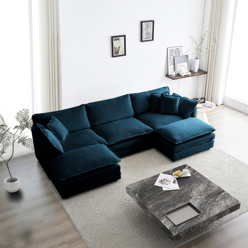 Canapé d'angle en chenille bleue en forme de U, 5 places avec repose-pieds réversible et 2 poufs, structure en bois massif, revêtement de qualité et fabrication soignée.