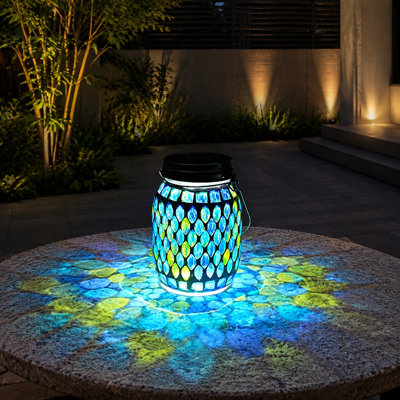 Handcrafted Blue mosaic glass forms this waterproof solar hanging garden lantern, projecting colorful decorative light outdoors and serving as a gift for Mom or garden lovers.