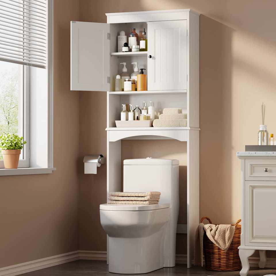 White over-the-toilet storage cabinet with open shelving and a closed cabinet door, featuring towels, toiletries, and an integrated toilet paper holder in a modern bathroom.