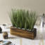 Herbes artificielles en pot de bois brûlé