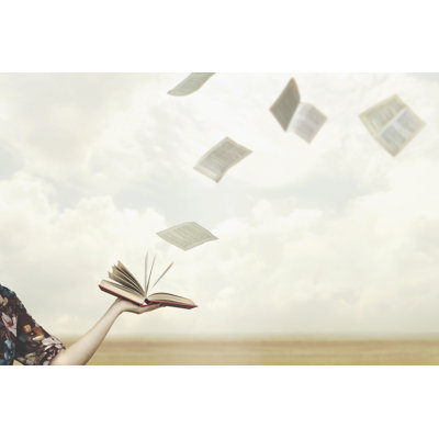 Pages Fly Free In The Sky From A Book Held Open By A Woman by Fcscafeine - Wrapped Canvas Print