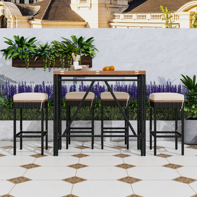5-Piece Wicker and Acacia Wood Outdoor Dining Table Set with Cushioned Stools and Foldable Table