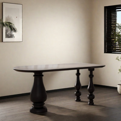 A table with a rock slab tabletop and three legs