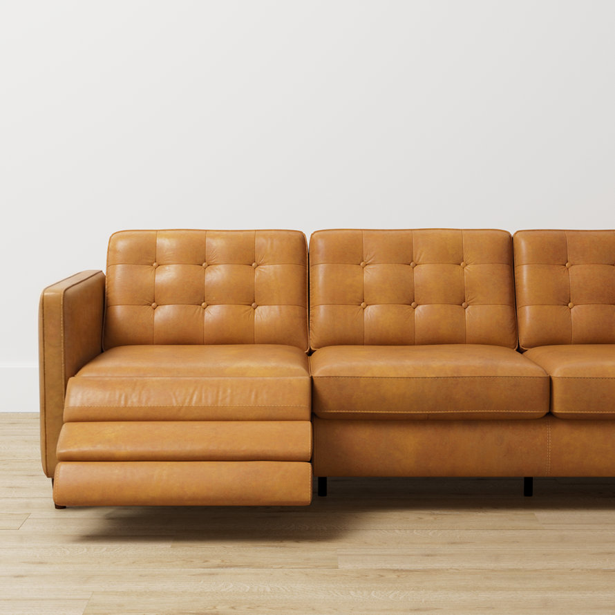A tan leather tufted sofa with a recliner.