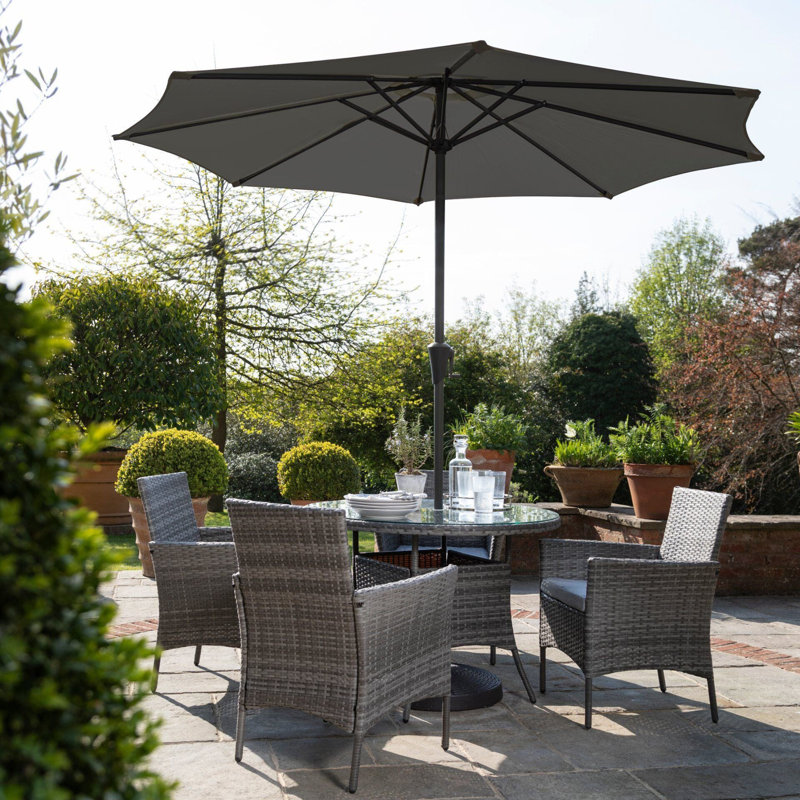 Dubose 4 - Person Wicker Patio Dining Set with Round Table , Cushions Included, Grey