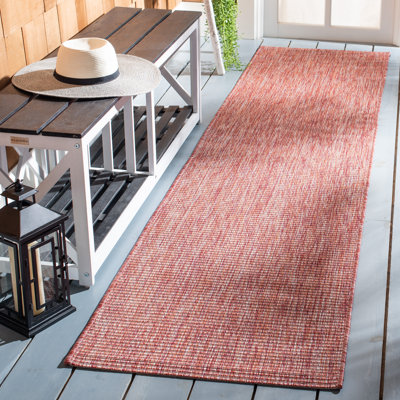 Tapis d'intérieur / extérieur de couleur unie Alaycia Performance