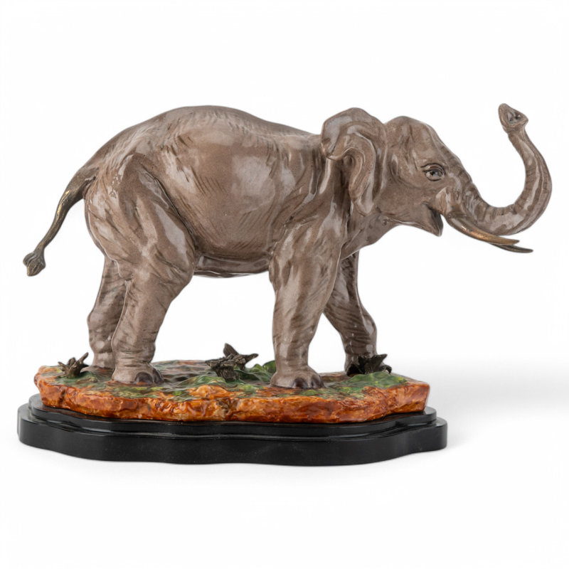 Porcelain Elephant Figurine With Bronze Tusks and Tail Accents On Wood Base
