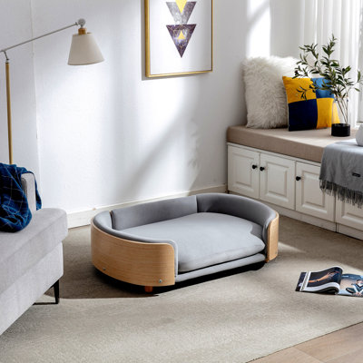 Lit pour chien surélevé de style scandinave avec pattes en bois massif et dossier en bois courbé, coussin en velours